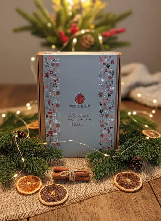 A miniature replica of a Christmas themed bottle label collection book with various Christmas motifs and text, indicating it's a limited edition festive collection.