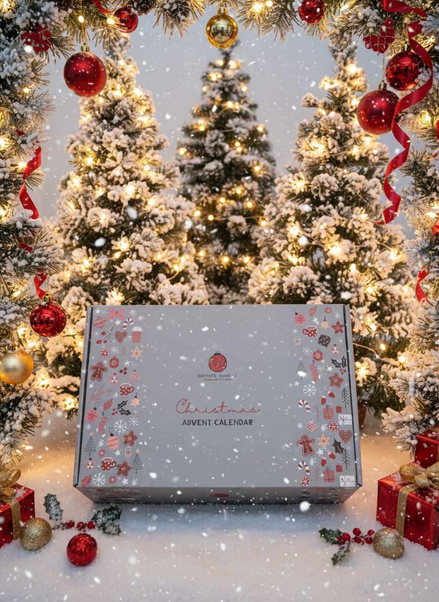 Christmas advent calendar in front of decorated trees with ornaments.