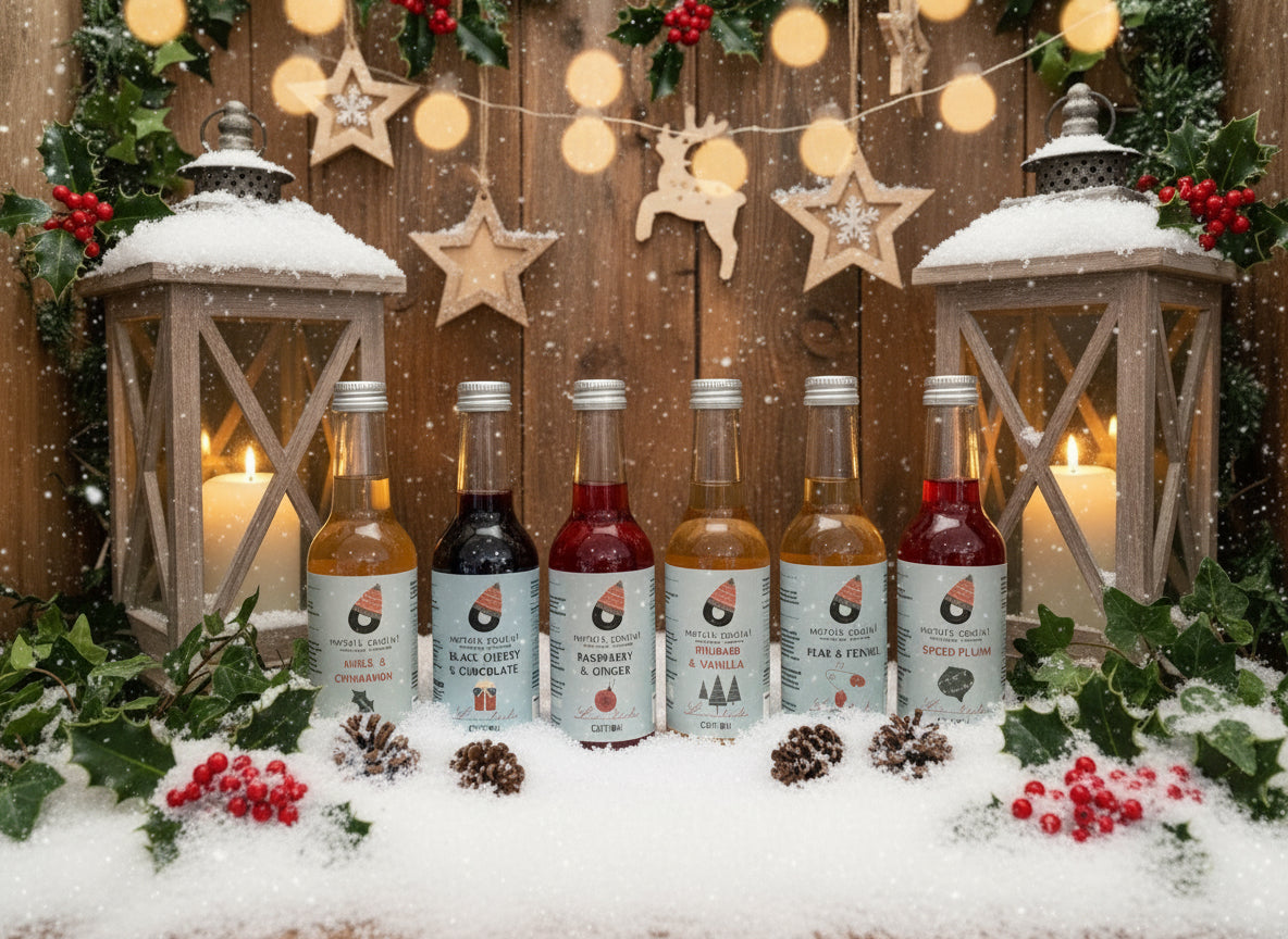 Six small bottles of Norfolk Cordial on a wooden surface with a rustic background.