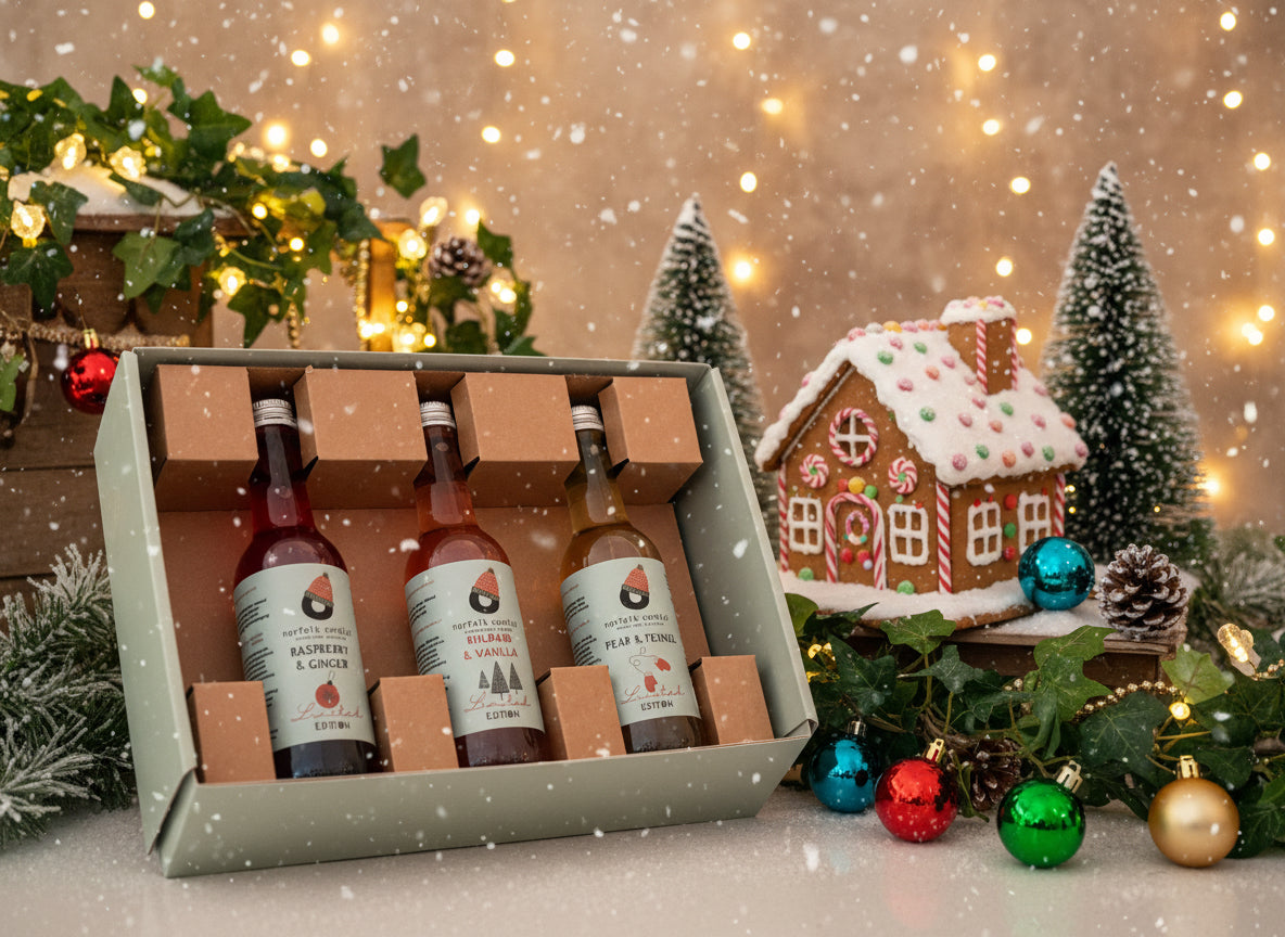 Three bottles of wine in a cardboard box with labels on a neutral background