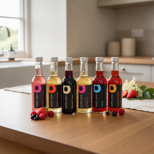 Norfolk Cordial 250ml bottles in assorted flavours displayed together on a kitchen table