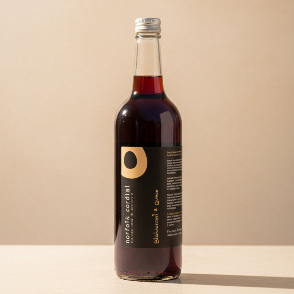 Norfolk Cordial Blackcurrant & Quince 750ml bottle on a warm neutral background