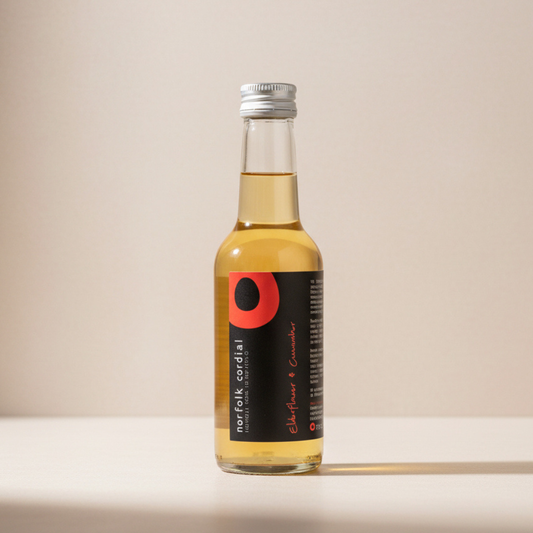 Norfolk Cordial Elderflower & Cucumber 250ml bottle on a warm neutral background