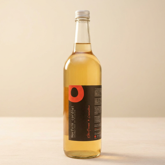 Norfolk Cordial Elderflower & Cucumber 750ml bottle on a warm neutral background