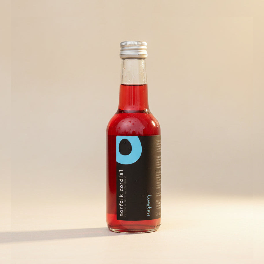 Norfolk Cordial Raspberry 250ml bottle on a warm neutral background