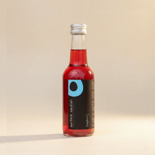 Norfolk Cordial Raspberry 250ml bottle on a warm neutral background