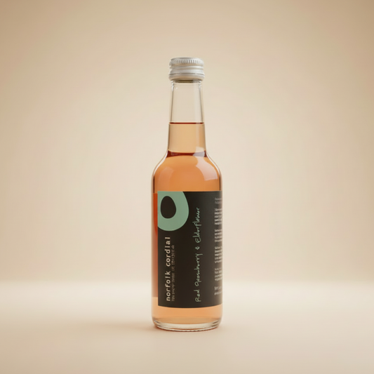 Norfolk Cordial Red Gooseberry & Elderflower 250ml bottle on a warm neutral background