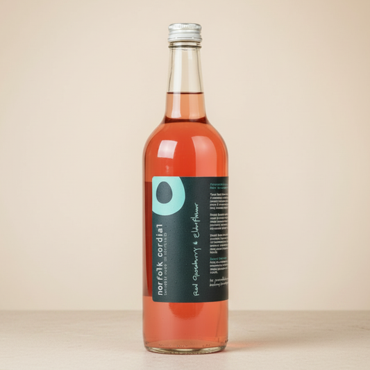 Norfolk Cordial Red Gooseberry & Elderflower 750ml bottle on a warm neutral background