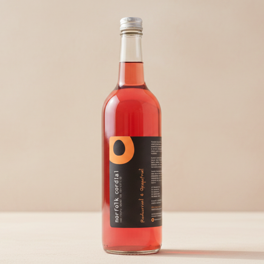Norfolk Cordial Redcurrant & Grapefruit 750ml bottle on a warm neutral background
