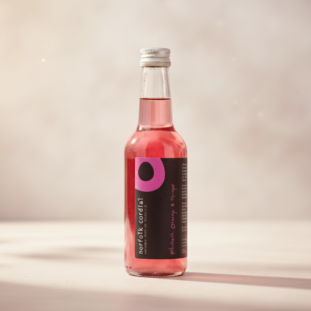 Norfolk Cordial Rhubarb, Orange & Ginger 250ml bottle on a warm neutral background